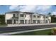 Modern townhome community with attached garages and neutral color palette at 1532 Hammer Pl, Largo, FL 33774