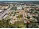 Aerial view showcasing a residential neighborhood with various houses and roads at 1597 Franklin Way, Dunedin, FL 34698