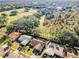 Aerial view of a residential neighborhood showcasing houses and lush green spaces at 1597 Franklin Way, Dunedin, FL 34698