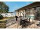 Inviting backyard patio with brick pavers, table, chairs, and sliding glass doors at 1597 Franklin Way, Dunedin, FL 34698