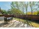 Relaxing backyard patio with brick pavers, table, chairs, and a view of the fenced yard at 1597 Franklin Way, Dunedin, FL 34698