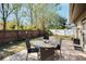 Cozy backyard patio with brick pavers and a table with four chairs at 1597 Franklin Way, Dunedin, FL 34698