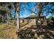 Large backyard with mature trees and wooden fence at 1597 Franklin Way, Dunedin, FL 34698