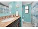 Stylish bathroom with granite vanity and a mermaid theme at 1597 Franklin Way, Dunedin, FL 34698