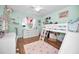 Charming bedroom with bunk beds, built-in shelving and a desk at 1597 Franklin Way, Dunedin, FL 34698