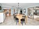 Open dining room with a wooden table and kitchen views at 1597 Franklin Way, Dunedin, FL 34698