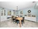 Bright dining room featuring a wooden table and built-in cabinetry at 1597 Franklin Way, Dunedin, FL 34698
