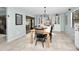 Bright dining room with a farmhouse table, black chairs, and access to a patio at 1597 Franklin Way, Dunedin, FL 34698