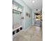 Light and airy entryway with built-in bench, shoe storage, and decorative accents at 1597 Franklin Way, Dunedin, FL 34698