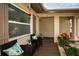 Inviting front porch with wicker chairs and lush greenery at 1597 Franklin Way, Dunedin, FL 34698