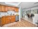 Kitchen with wood cabinets, granite counters, and view to dining room at 1597 Franklin Way, Dunedin, FL 34698