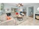 Bright living room with sectional sofa, coffee table, and views into the dining area at 1597 Franklin Way, Dunedin, FL 34698