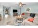 Relaxing living room featuring a sectional sofa and a large-screen TV at 1597 Franklin Way, Dunedin, FL 34698