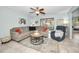 Spacious living room featuring a comfortable sectional sofa, a coffee table, and a ceiling fan at 1597 Franklin Way, Dunedin, FL 34698