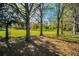 Open green space with mature trees, ideal for recreation and relaxation at 1597 Franklin Way, Dunedin, FL 34698