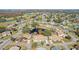 Aerial close-up showcasing a house in a community near a pond at 2243 Greenwich Dr, Sun City Center, FL 33573