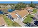 Aerial view of a single-story home near a pond at 2243 Greenwich Dr, Sun City Center, FL 33573