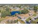 Aerial view of a community with houses,ponds, and lush green landscape at 2243 Greenwich Dr, Sun City Center, FL 33573