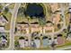 Aerial view of houses near a pond in a community at 2243 Greenwich Dr, Sun City Center, FL 33573