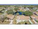 Aerial view of community with pond and numerous homes at 2243 Greenwich Dr, Sun City Center, FL 33573