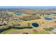 Aerial view of a golf course community with multiple ponds at 2243 Greenwich Dr, Sun City Center, FL 33573