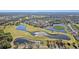 Aerial view of a golf course community with water features at 2243 Greenwich Dr, Sun City Center, FL 33573