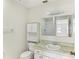 Clean bathroom, with shower, vanity, and linen cabinet at 2243 Greenwich Dr, Sun City Center, FL 33573