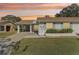 Single-story home with carport and landscaping at 2243 Greenwich Dr, Sun City Center, FL 33573