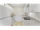 Bright kitchen features white appliances and cabinetry at 2243 Greenwich Dr, Sun City Center, FL 33573