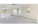 Spacious living room with neutral carpeting and view to porch at 2243 Greenwich Dr, Sun City Center, FL 33573