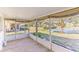 Screened-in porch overlooking a serene lake view at 2243 Greenwich Dr, Sun City Center, FL 33573