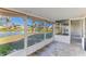 Screened porch overlooking a pond and serene landscape at 2243 Greenwich Dr, Sun City Center, FL 33573