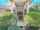 Elegant entryway with double doors and manicured landscaping at 2244 Pinnacle S Cir, Palm Harbor, FL 34684