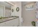 Updated bathroom with granite countertop, white cabinets, and decorative shower curtain at 238 71St Ave, St Pete Beach, FL 33706