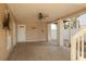 Spacious covered patio with tile flooring, ceiling fan, and exterior access at 238 71St Ave, St Pete Beach, FL 33706