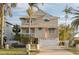 Two-story house with a white garage door and a paved driveway at 238 71St Ave, St Pete Beach, FL 33706