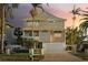 Two-story house with a large garage and landscaped yard at 238 71St Ave, St Pete Beach, FL 33706