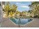 Relaxing kidney-shaped pool with brick patio and tropical landscaping at 238 71St Ave, St Pete Beach, FL 33706