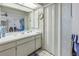 Bright bathroom with vanity, mirror, and access to bedroom at 2530 Oakleaf Ln # 31A, Clearwater, FL 33763
