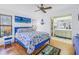 Bedroom with a blue bed, nautical-themed bedding, and ensuite bathroom access at 2530 Oakleaf Ln # 31A, Clearwater, FL 33763