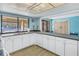 Community kitchen with white cabinets, view of pool at 2530 Oakleaf Ln # 31A, Clearwater, FL 33763