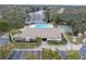 Community pool, shuffleboard, and clubhouse with lake view at 2530 Oakleaf Ln # 31A, Clearwater, FL 33763