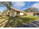 Exterior view of a single-story home with carport, landscaping, and a paved driveway at 2530 Oakleaf Ln # 31A, Clearwater, FL 33763