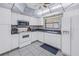 White kitchen with standard appliances and dark countertops at 2530 Oakleaf Ln # 31A, Clearwater, FL 33763