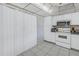 White kitchen with built-in microwave, range, and ample cabinet space at 2530 Oakleaf Ln # 31A, Clearwater, FL 33763