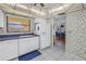 White kitchen with a built-in refrigerator, dishwasher, and window overlooking the yard at 2530 Oakleaf Ln # 31A, Clearwater, FL 33763