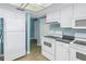 Kitchen with white cabinets and appliances at 2530 Oakleaf Ln # 31A, Clearwater, FL 33763
