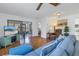 Living room with light wood floors, blue sofa, and access to a screened porch at 2530 Oakleaf Ln # 31A, Clearwater, FL 33763