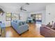 Spacious living room with hardwood floors, blue sofa, and access to a patio at 2530 Oakleaf Ln # 31A, Clearwater, FL 33763