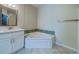 Bathroom features a corner soaking tub and updated white vanity at 2741 Via Cipriani # 930A, Clearwater, FL 33764